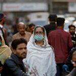 Corona kills 59 more People, 1,000 Positive Cases Reported Woman wearing Mask in Market due to Covid-19