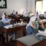 Schools Are Again Closing In Major Cities For Two Weeks School Students in Class Room with Safety Precautions